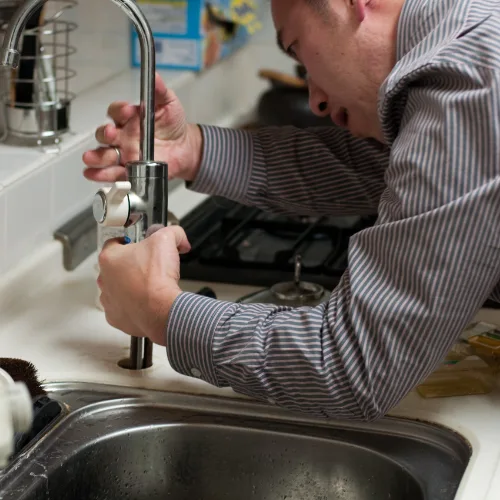 plumber fixing sink