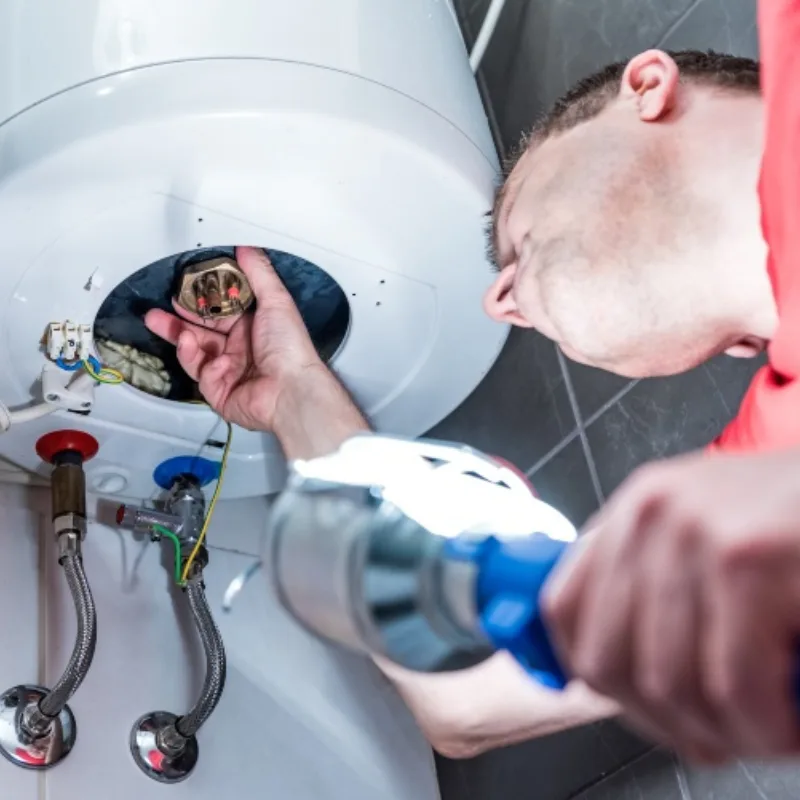 plumber fixing water heater